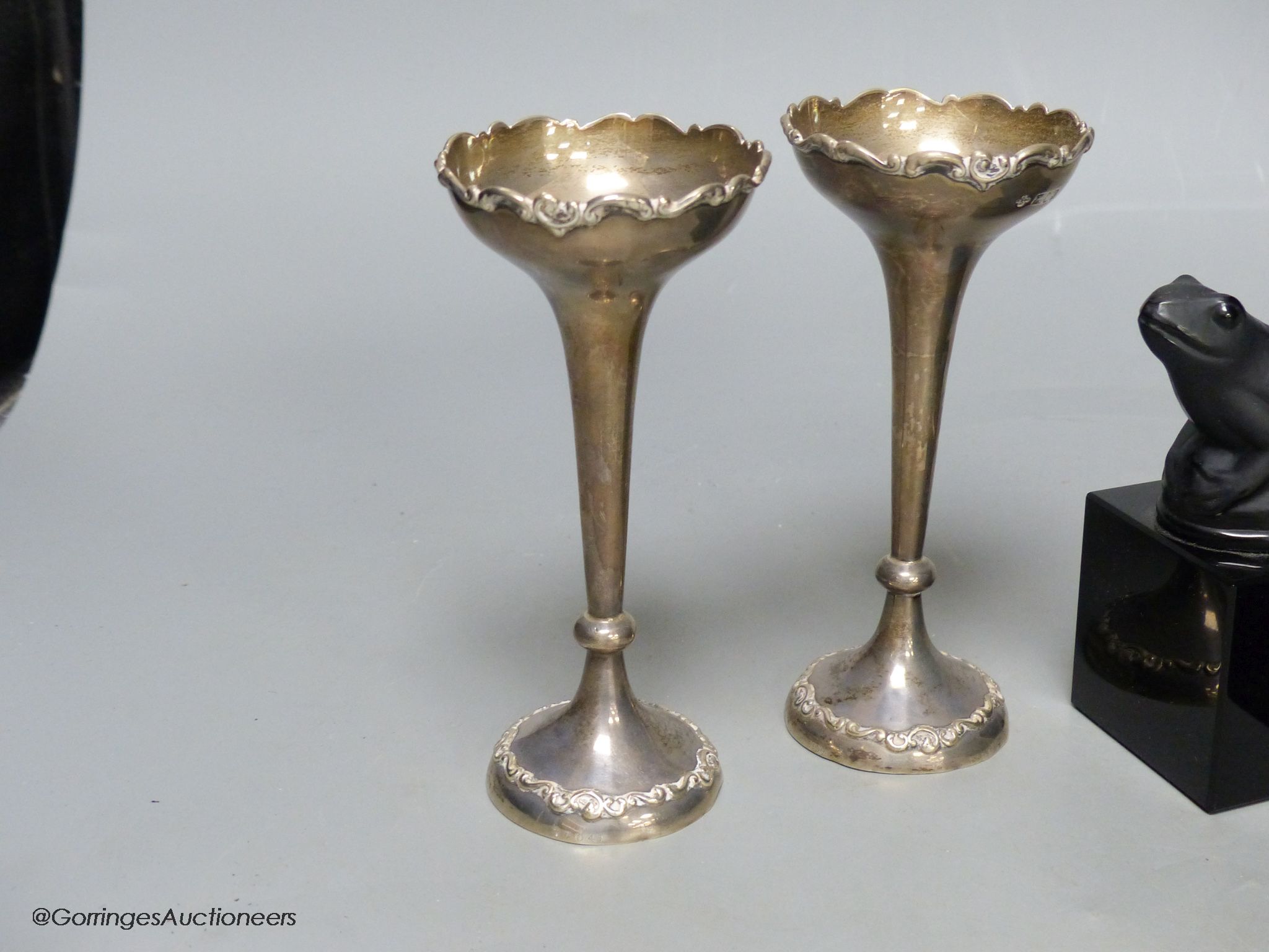 A pair of silver specimen vases, height 14cm, and a pair of black glass frogs